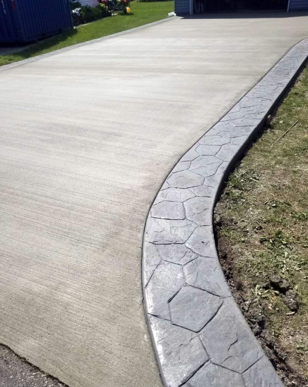 Curved concrete driveway poured to the approach of a home